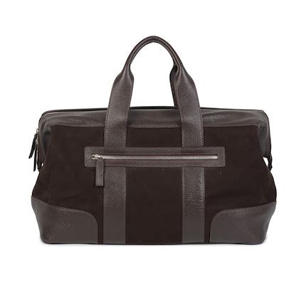 Patek Philippe. A brown leather and cloth duffle bag